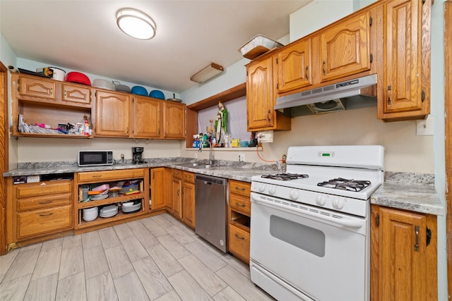 kitchen featuring stainless steel dishwasher, white range with gas cooktop, light hardwood / wood-style floors, and sink