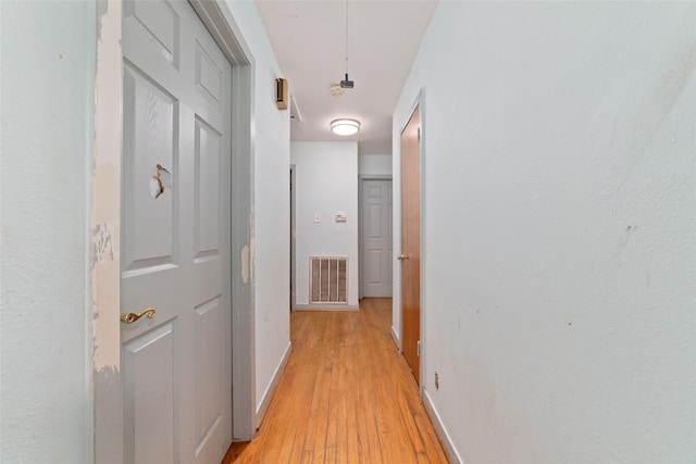 corridor with light hardwood / wood-style floors