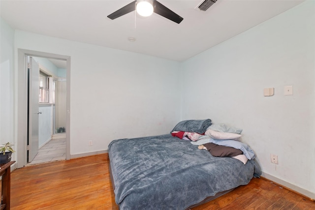 bedroom with hardwood / wood-style floors and ceiling fan