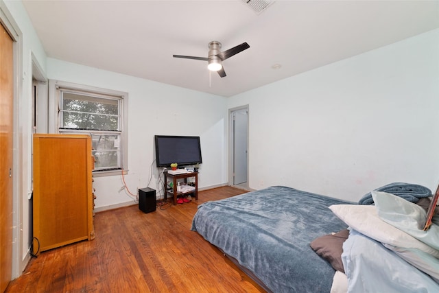 bedroom with wood-type flooring and ceiling fan