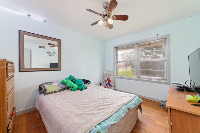 bedroom with ceiling fan and wood-type flooring