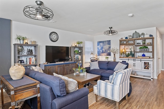 living room with hardwood / wood-style flooring and ceiling fan