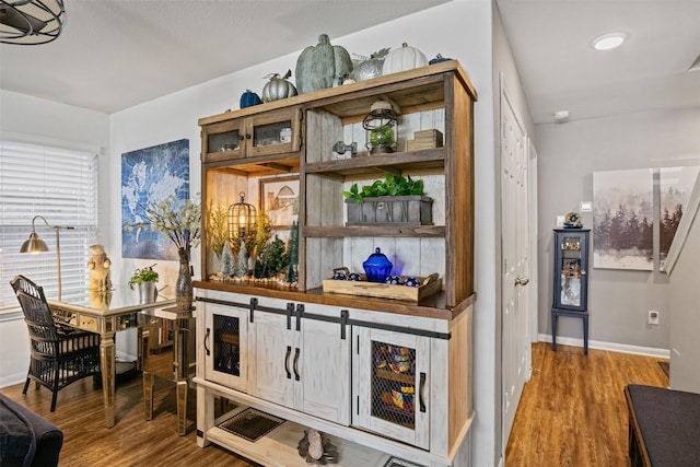 bar with hardwood / wood-style flooring