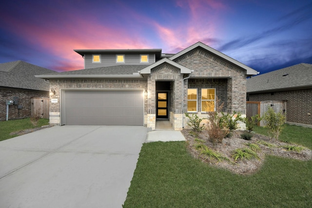 view of front of property featuring concrete driveway, fence, brick siding, and a garage