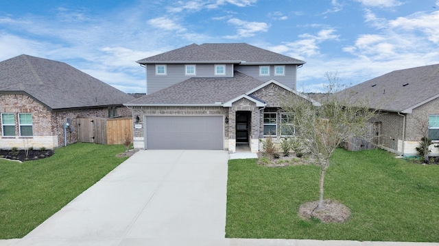 view of front of home with fence, concrete driveway, a front yard, roof with shingles, and an attached garage