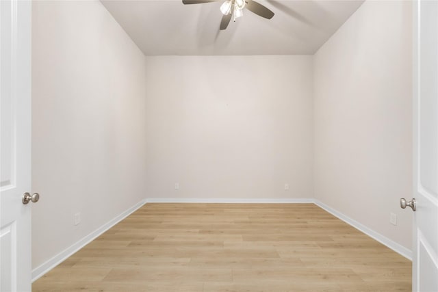 empty room featuring ceiling fan, light wood finished floors, and baseboards