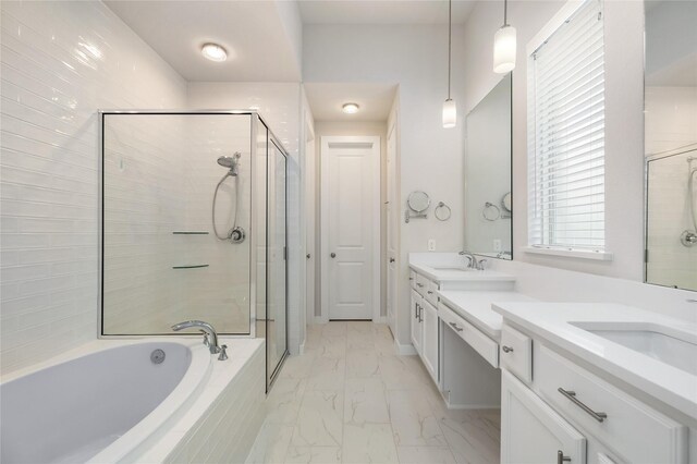 bathroom with a stall shower, marble finish floor, vanity, and a bath