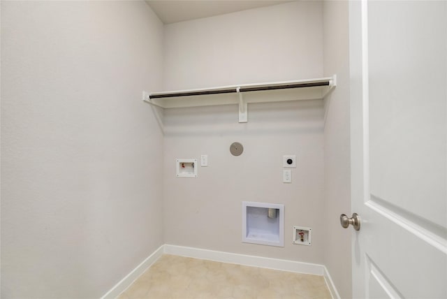 clothes washing area with washer hookup, hookup for an electric dryer, gas dryer hookup, laundry area, and baseboards