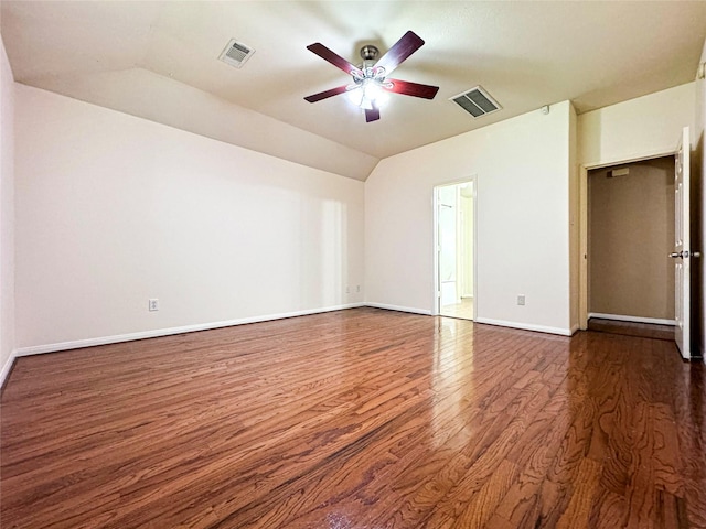 spare room with ceiling fan, dark hardwood / wood-style floors, and vaulted ceiling