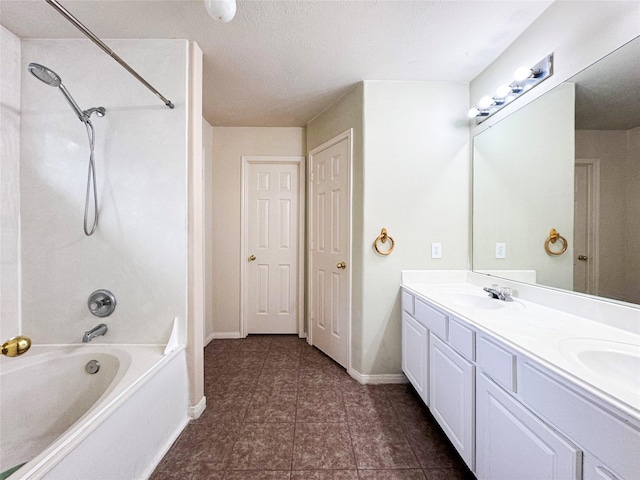 bathroom featuring vanity, shower / bathtub combination, and a textured ceiling