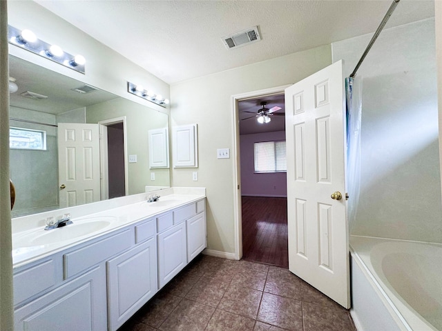 bathroom with vanity, a wealth of natural light, tile patterned floors, and ceiling fan