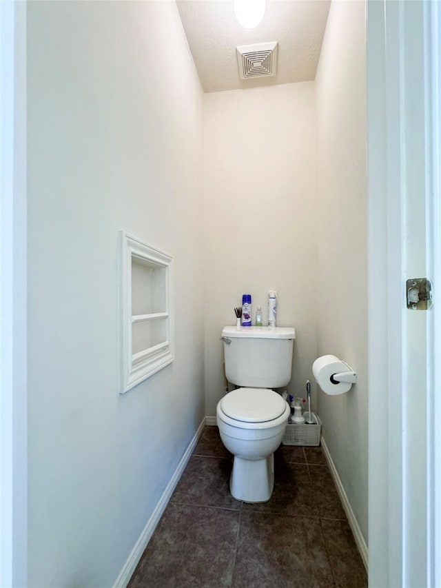 bathroom with tile patterned floors and toilet