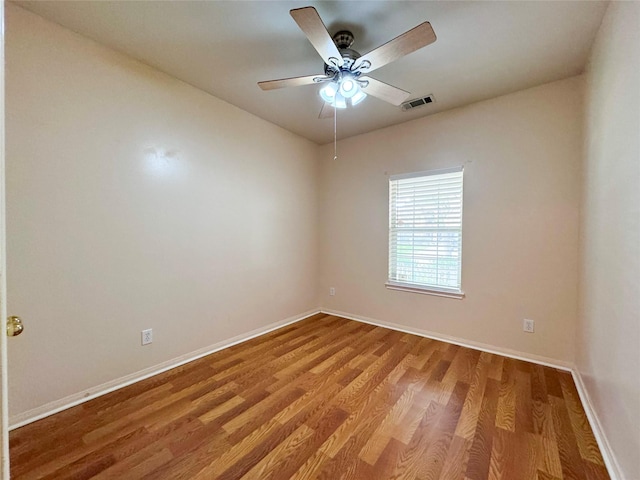 spare room featuring hardwood / wood-style flooring and ceiling fan