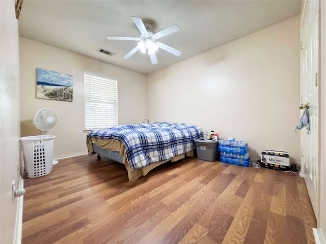 bedroom with ceiling fan and light wood-type flooring