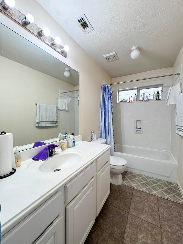 full bathroom featuring tile patterned floors, toilet, a textured ceiling, vanity, and shower / bath combination with curtain