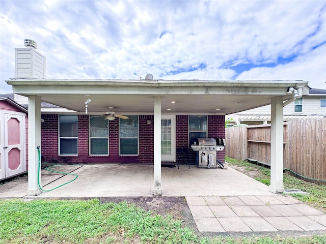 back of house featuring a shed, a patio area, and ceiling fan