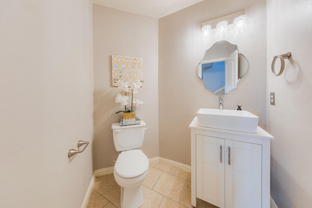 bathroom featuring vanity, tile patterned floors, and toilet