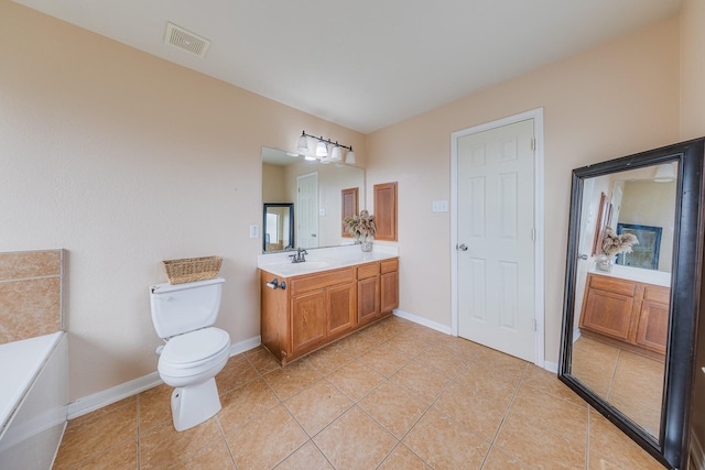 bathroom with tile patterned flooring, vanity, and toilet