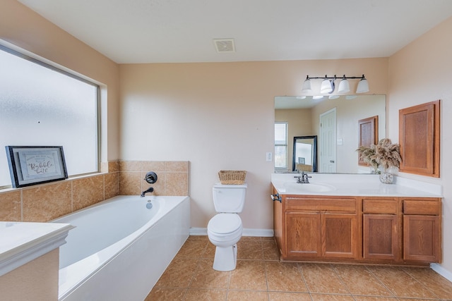 bathroom with vanity, tile patterned floors, a bathtub, and toilet