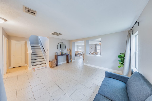 living room featuring a wealth of natural light and light tile patterned floors