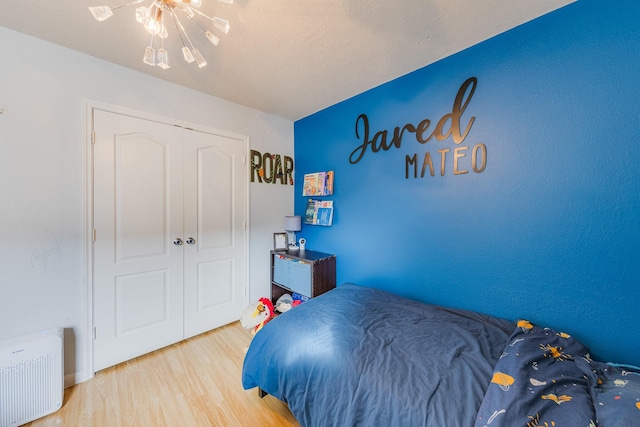 bedroom with a closet and light hardwood / wood-style flooring