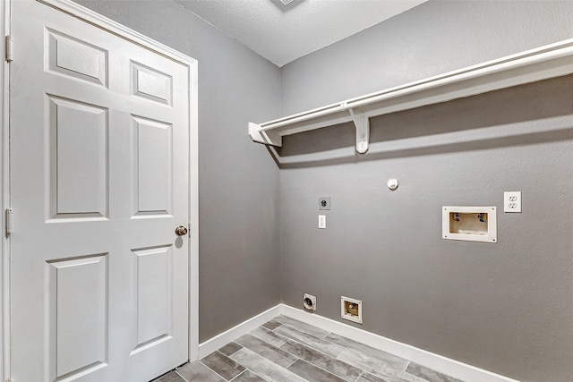 laundry room featuring gas dryer hookup, electric dryer hookup, wood-type flooring, and washer hookup