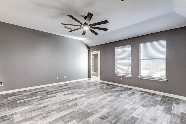 unfurnished room featuring ceiling fan, vaulted ceiling, and light wood-type flooring