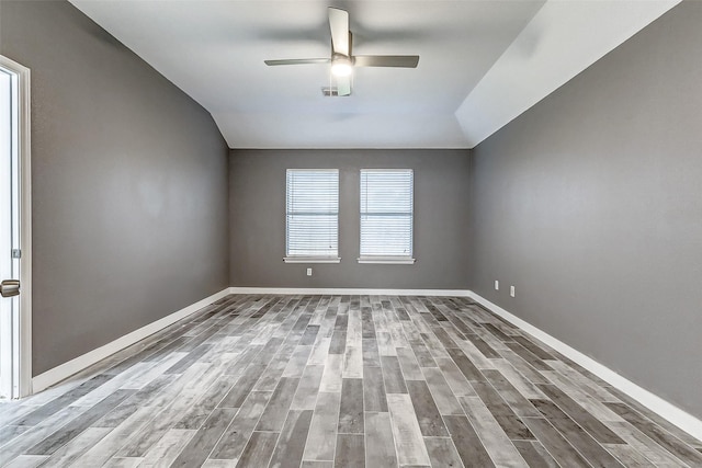 unfurnished room with vaulted ceiling, ceiling fan, and light wood-type flooring