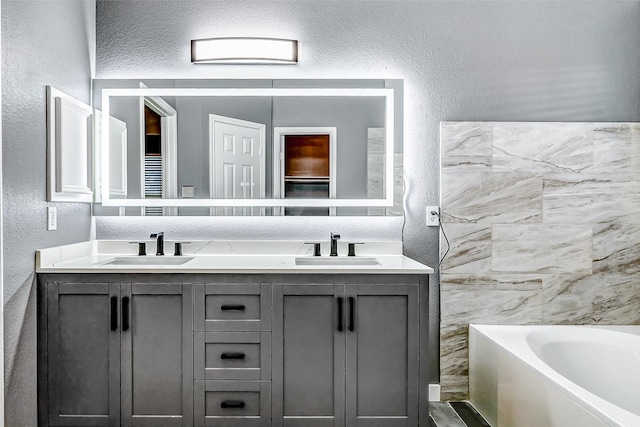 bathroom with a bathing tub and vanity