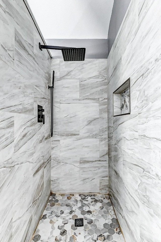 bathroom with tiled shower