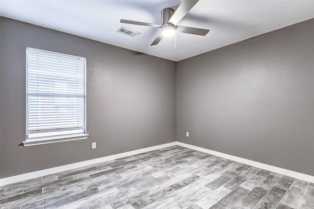 spare room with ceiling fan and light wood-type flooring