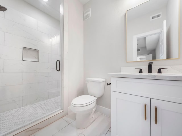 bathroom featuring vanity, toilet, and a shower with shower door