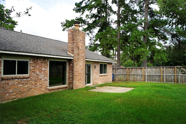 back of house featuring a yard