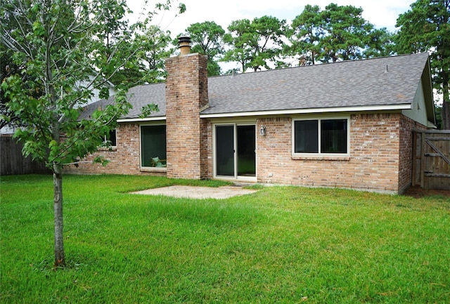 rear view of house featuring a yard and a patio area