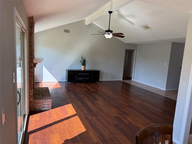 living room featuring ceiling fan, vaulted ceiling with beams, a textured ceiling, and dark hardwood / wood-style flooring