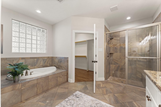 bathroom featuring independent shower and bath and vanity