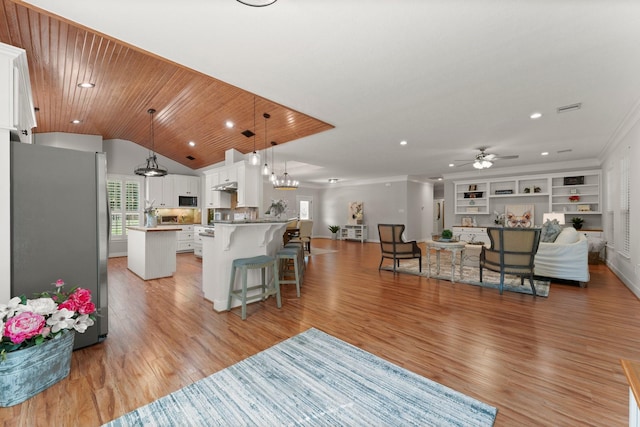 living room featuring built in shelves, lofted ceiling, light hardwood / wood-style floors, and wooden ceiling