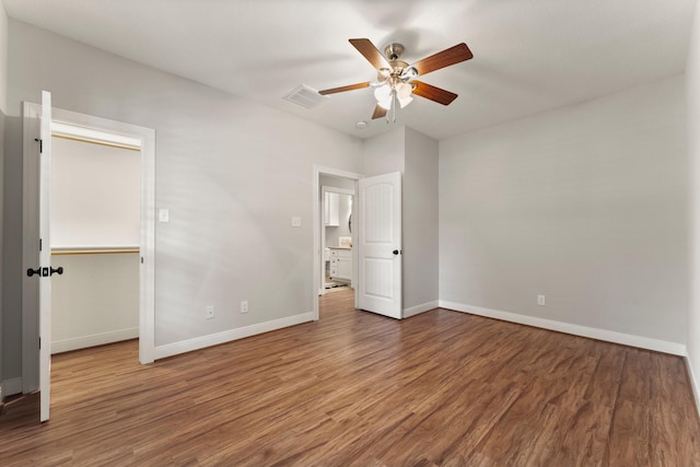 unfurnished bedroom featuring ceiling fan and dark hardwood / wood-style floors