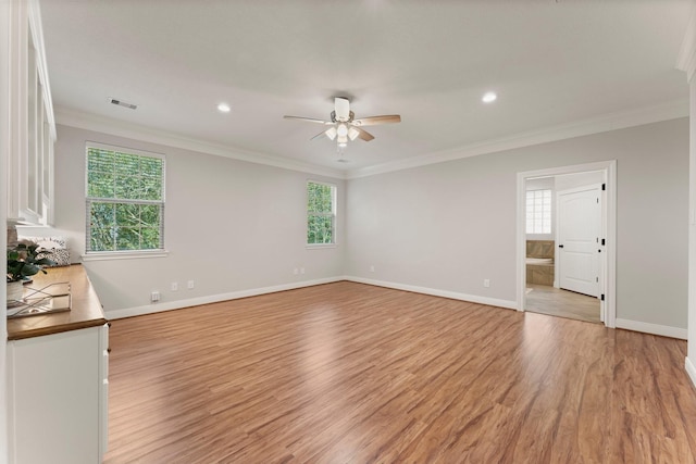 empty room featuring crown molding, ceiling fan, and light wood-type flooring