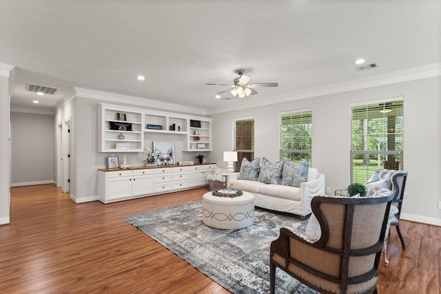 living room featuring crown molding, hardwood / wood-style flooring, and ceiling fan