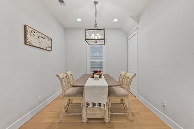 dining area featuring a chandelier and light wood-type flooring