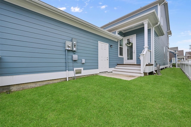 back of house with a lawn