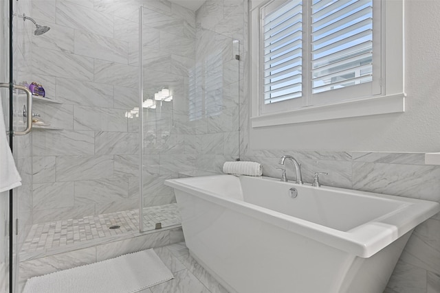 bathroom featuring separate shower and tub and tile walls