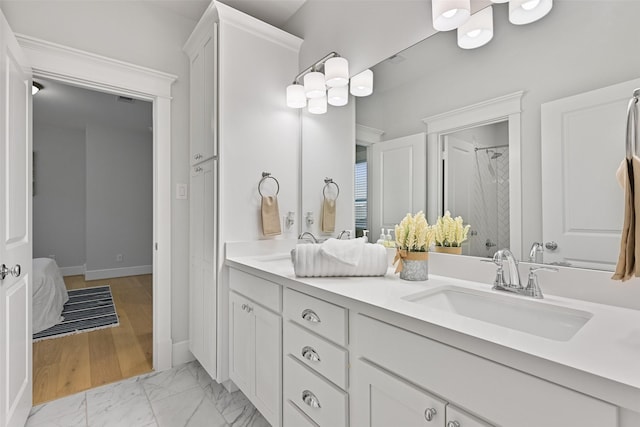 bathroom with walk in shower and vanity