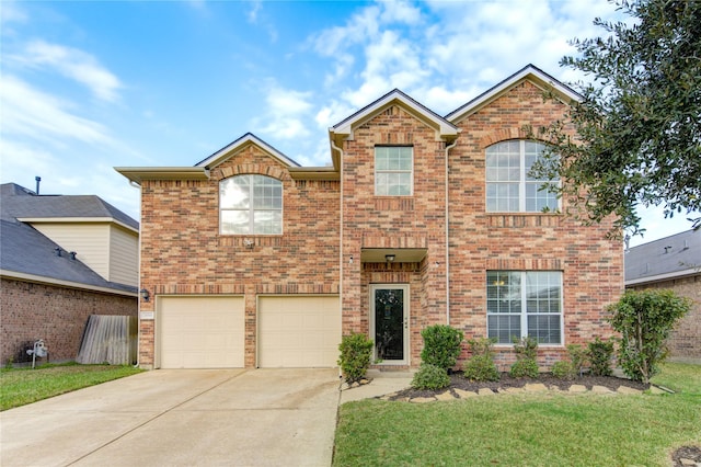 traditional home featuring a garage, a front lawn, concrete driveway, and brick siding