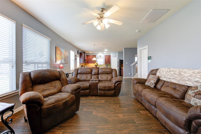 living area with ceiling fan, dark wood-style flooring, visible vents, and baseboards