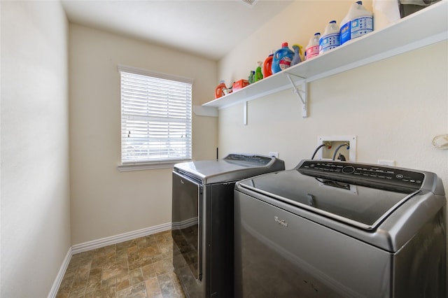 washroom featuring laundry area, stone finish flooring, baseboards, and independent washer and dryer