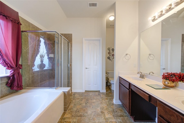 bathroom with double vanity, visible vents, toilet, a bath, and a sink