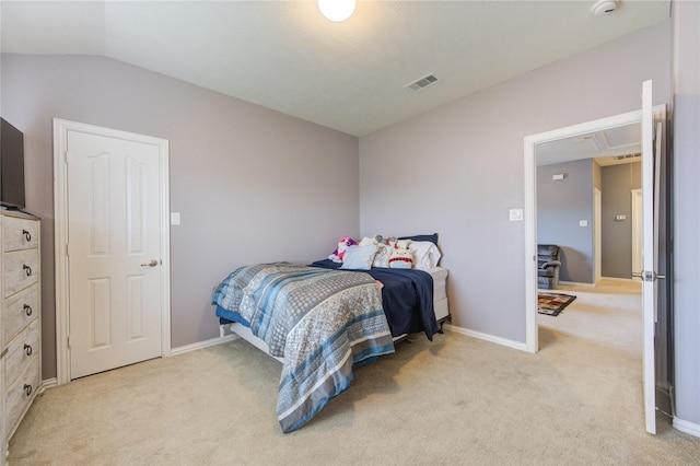 bedroom featuring light colored carpet, vaulted ceiling, visible vents, and baseboards