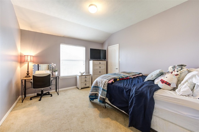 bedroom featuring lofted ceiling, light carpet, and baseboards